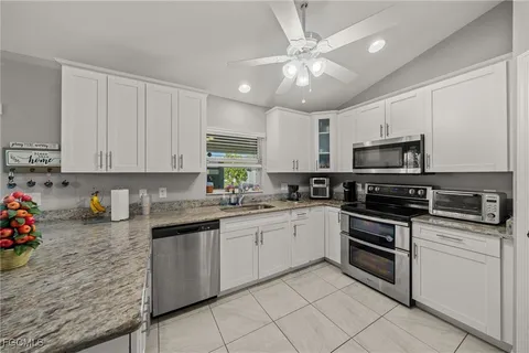 a kitchen with cabinets appliances and a sink