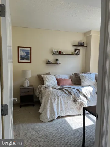 a bed sitting in a bedroom next to a window