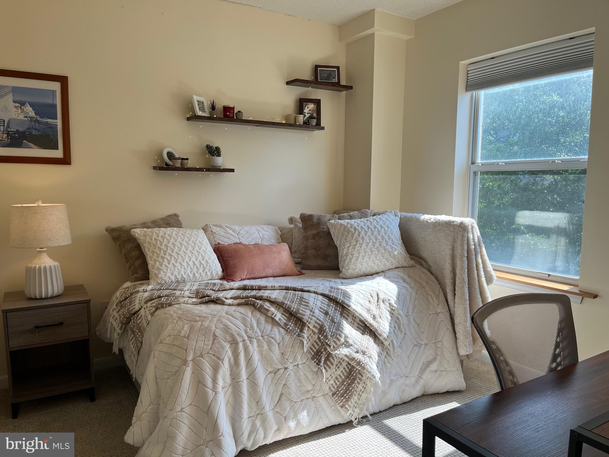 1111 11th Street Northwest, Unit 304 Washington, DC 20001 - Photo 15 of 27 a bed sitting in a bedroom next to a window