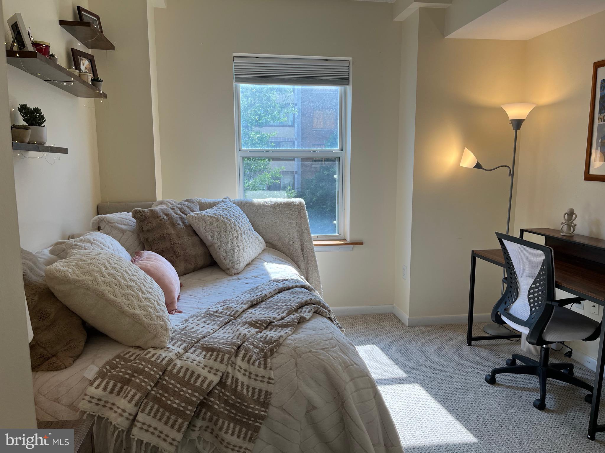 1111 11th Street Northwest, Unit 304 Washington, DC 20001 - Photo 16 of 27 a bed sitting in a bedroom next to a window