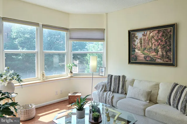 a living room with furniture and a large window