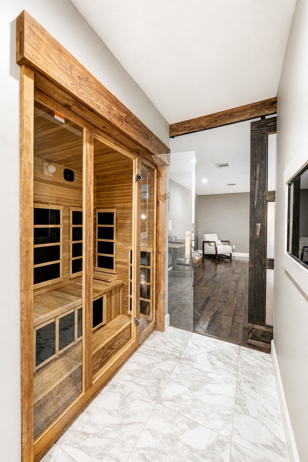 201 Vanderpool Lane, Unit 130 Houston, TX 77024 - Photo 25 of 41 Another view of the sauna. A wide sliding door hung from a wooden lintel separates the bathroom from bedroom.