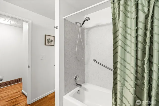 a bathroom with a shower and a sink