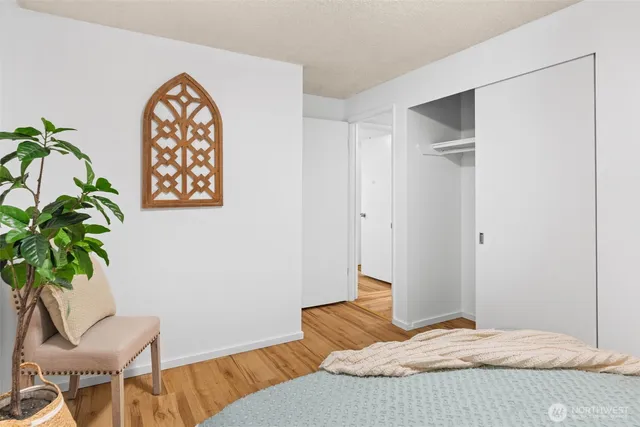 a bedroom with a bed and a potted plant