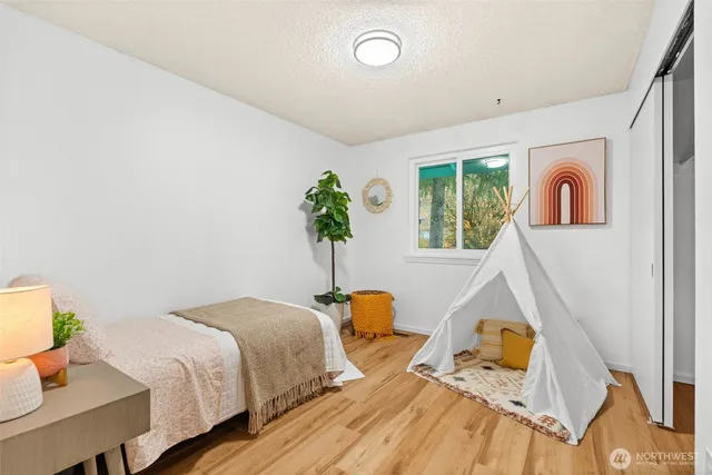 a bedroom with a bed and a window