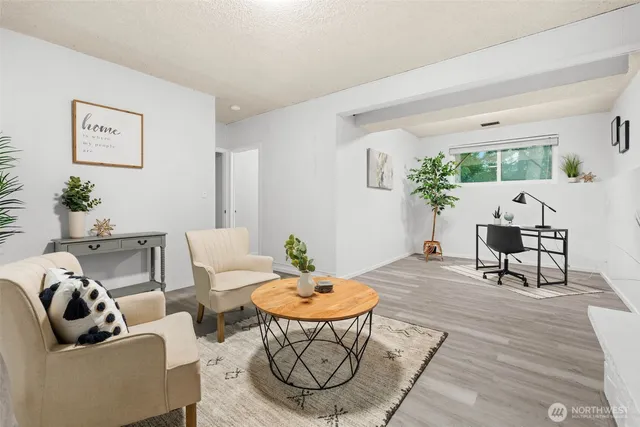 a living room with furniture and a mirror