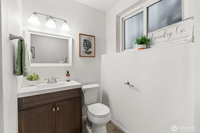a bathroom with a toilet sink and mirror