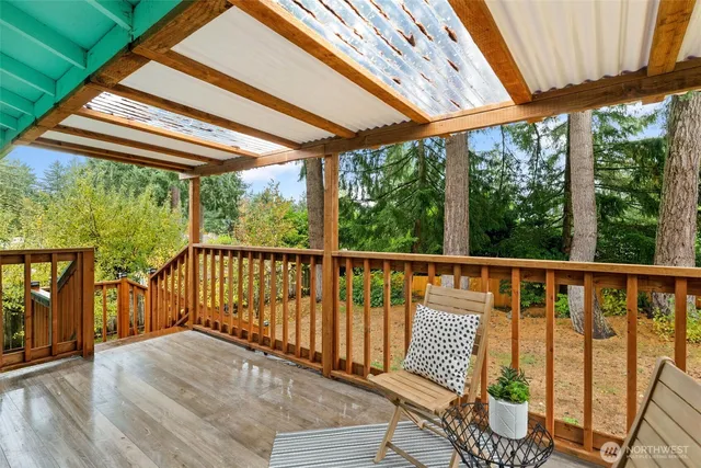 a view of balcony with wooden floor and outdoor seating