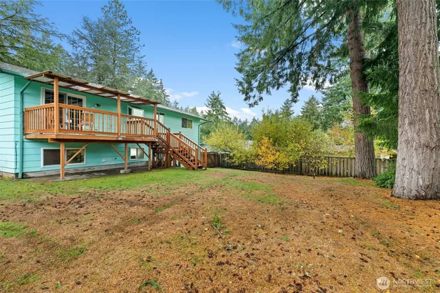 a view of a house with a yard and sitting area