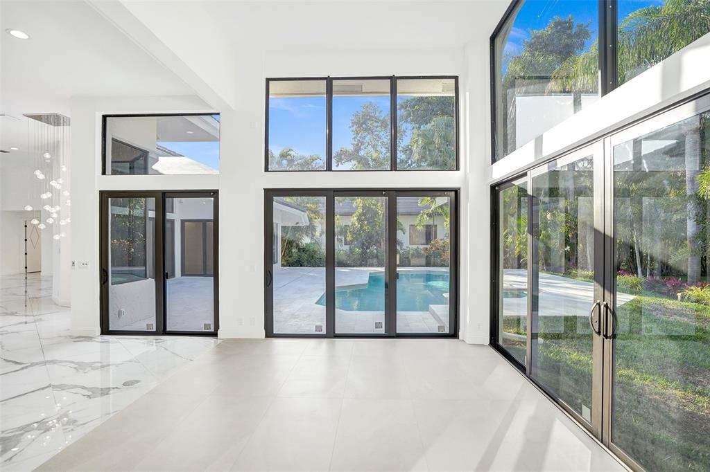 4701 Pine Tree Drive Boynton Beach, FL 33436 - Photo 24 of 76 a view of an empty room with a floor to ceiling window and a city view