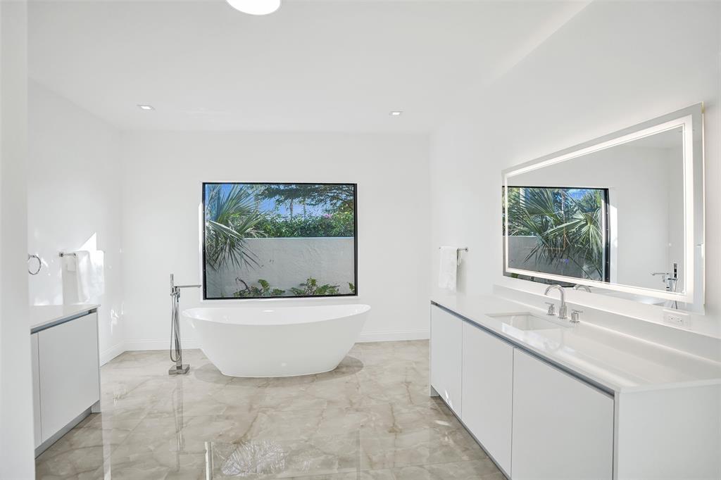 4701 Pine Tree Drive Boynton Beach, FL 33436 - Photo 34 of 76 a bathroom with a granite countertop sink and a bathtub