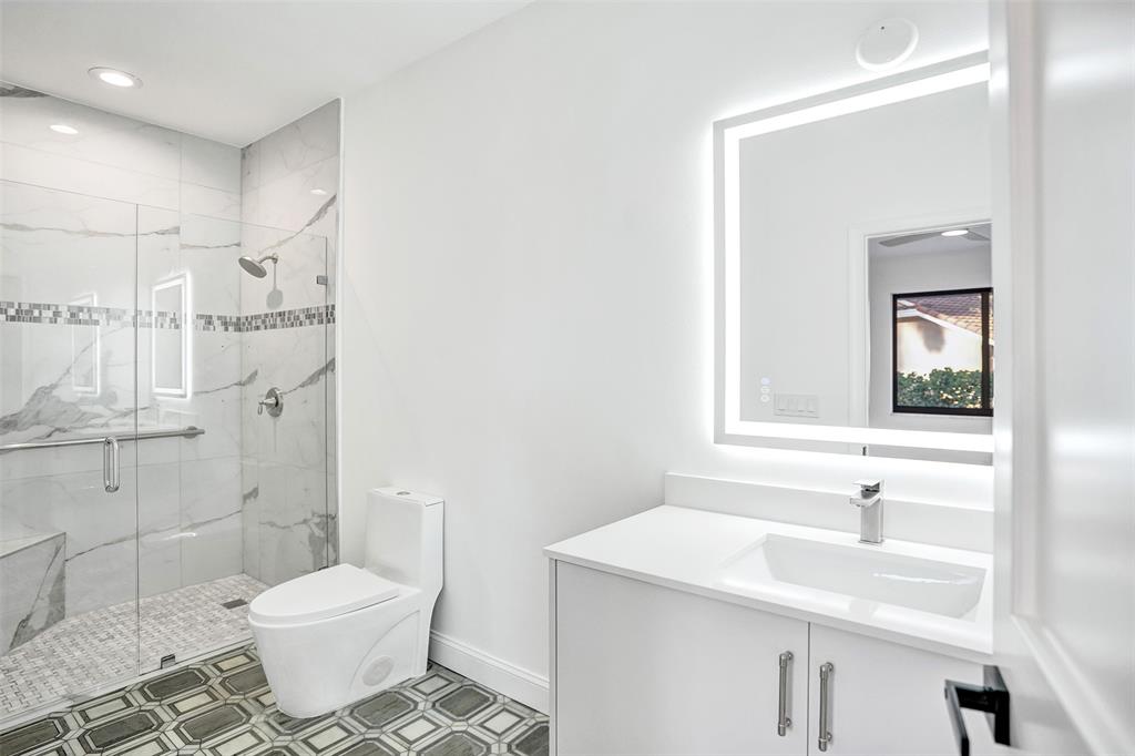 4701 Pine Tree Drive Boynton Beach, FL 33436 - Photo 40 of 76 a bathroom with a sink toilet and shower