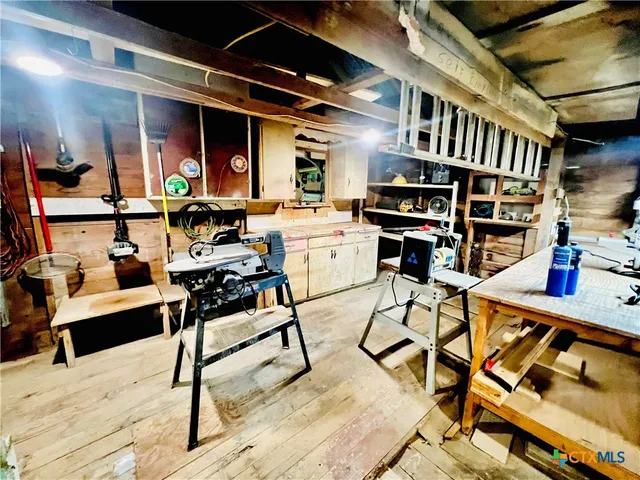 a workspace with lots of wooden furniture