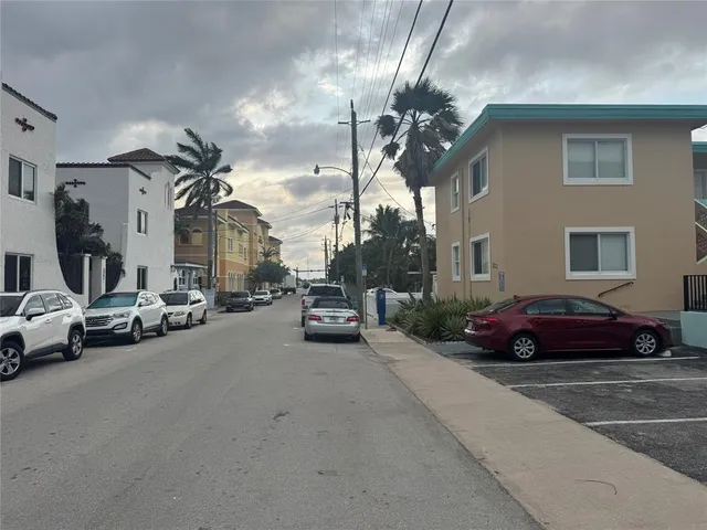 a view of a cars park in front of a house
