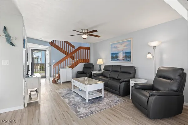 a living room with furniture and a wooden floor