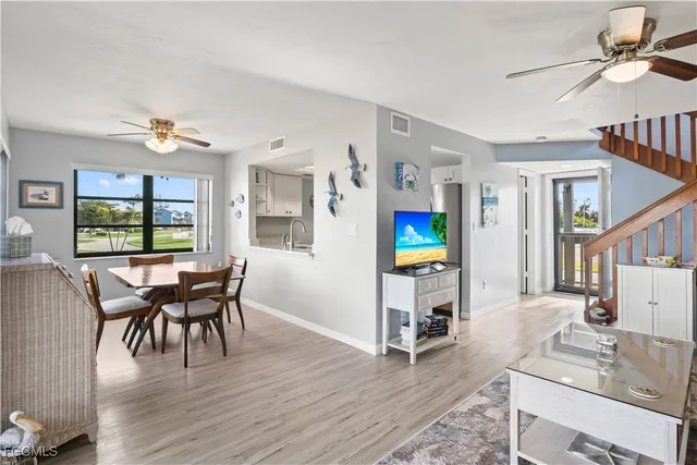 a view of a livingroom with furniture and a table chairs