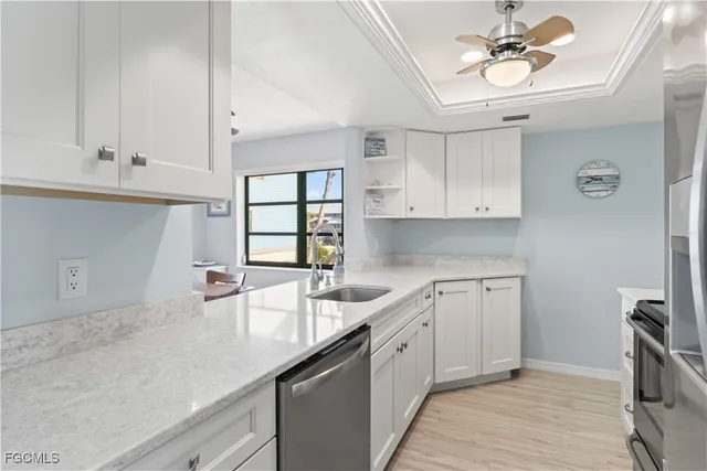 a kitchen with a sink cabinets and window