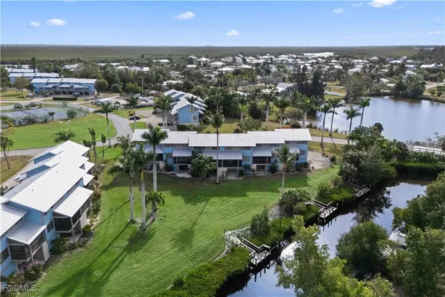 an aerial view of a house with a garden and lake view
