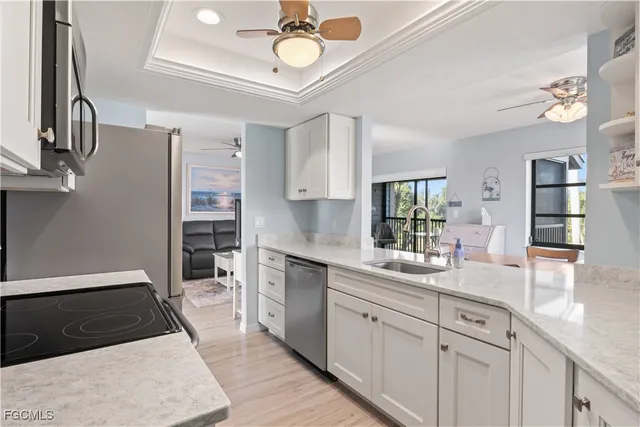 a kitchen with a sink appliances and cabinets