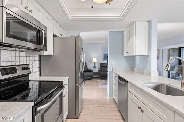 a kitchen with a sink stove and microwave