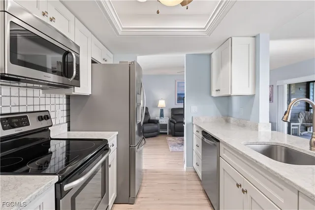 a kitchen with a sink stove and microwave