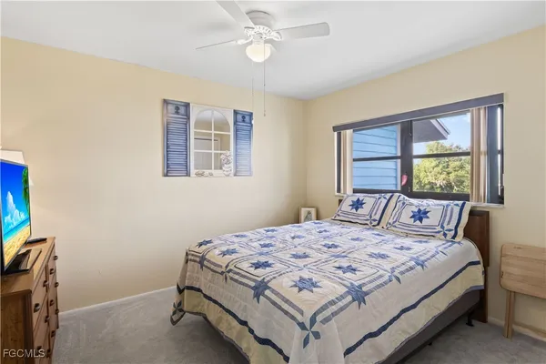 a bedroom with a bed a dresser and a window