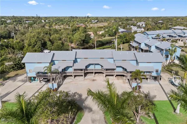 a view of a house with pool and chairs