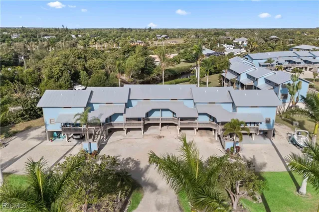 a view of a house with pool and chairs