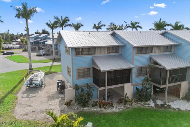 a view of a house with backyard porch and sitting area