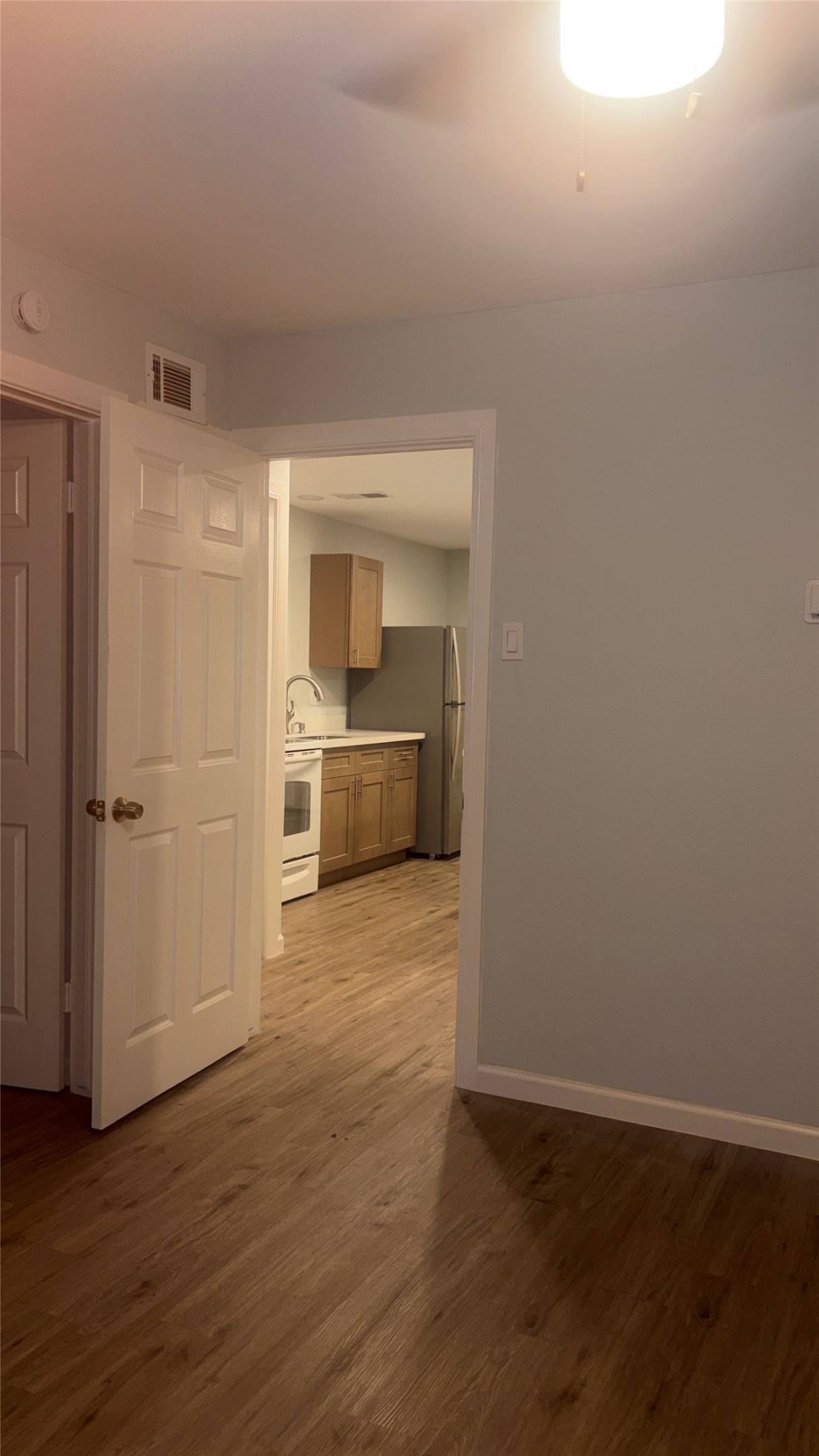 4624 Bell Street, Unit 2 Houston, TX 77023 - Photo 8 of 10 a view of empty room with wooden floor and cabinet