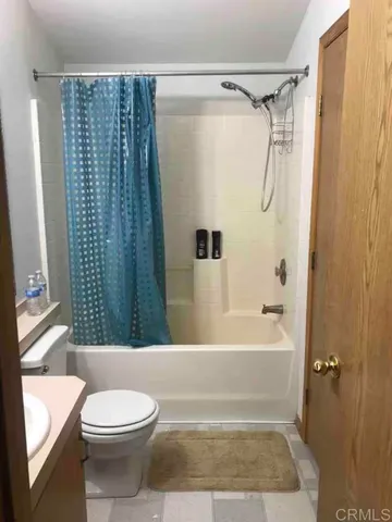 a bathroom with a toilet a sink and shower