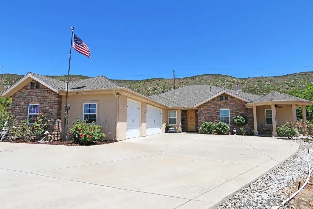 24568 Rutherford Road Ramona, CA 92065 - Photo 1 of 25 a front view of a house with a yard