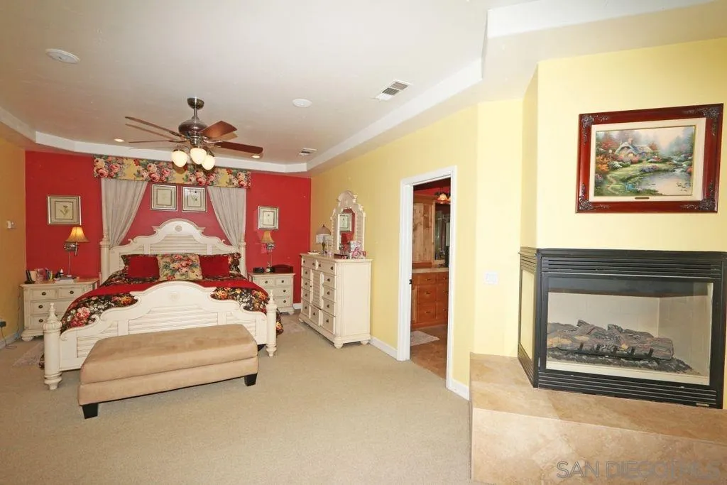 24568 Rutherford Road Ramona, CA 92065 - Photo 11 of 25 a bedroom with a bed and a painting on the wall