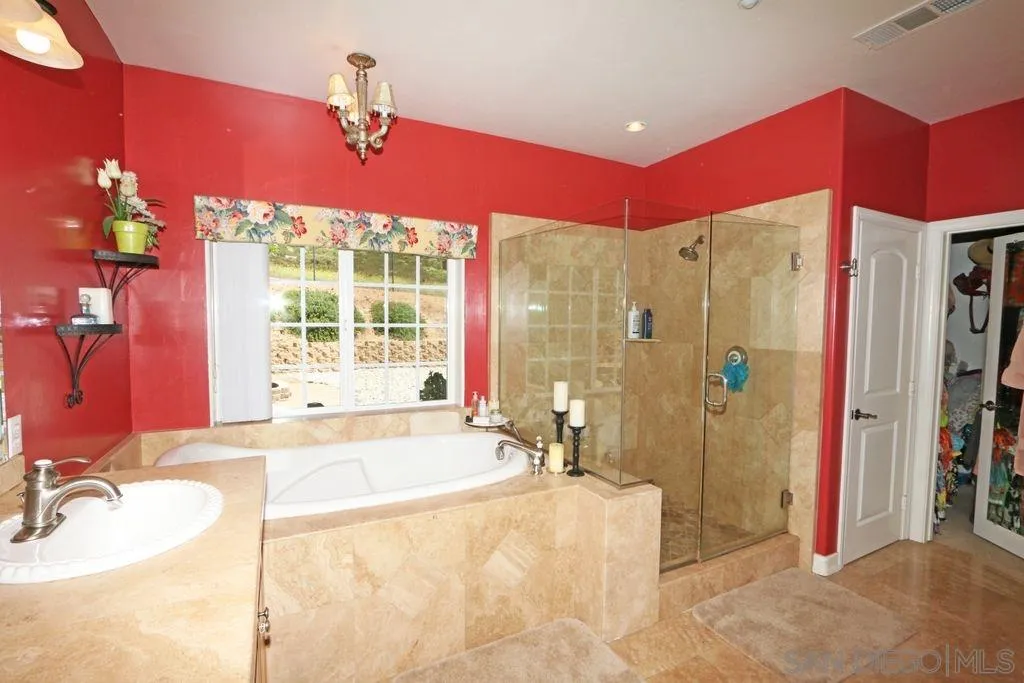 24568 Rutherford Road Ramona, CA 92065 - Photo 13 of 25 a spacious bathroom with a tub sink shower and a mirror