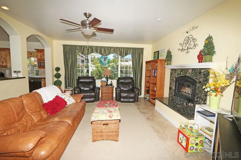 24568 Rutherford Road Ramona, CA 92065 - Photo 17 of 25 a living room with furniture fireplace and flat screen tv