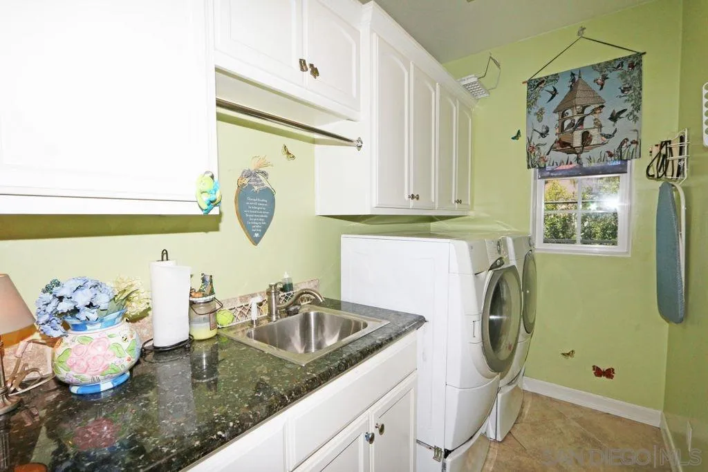 24568 Rutherford Road Ramona, CA 92065 - Photo 19 of 25 a bathroom with a granite countertop sink and a mirror