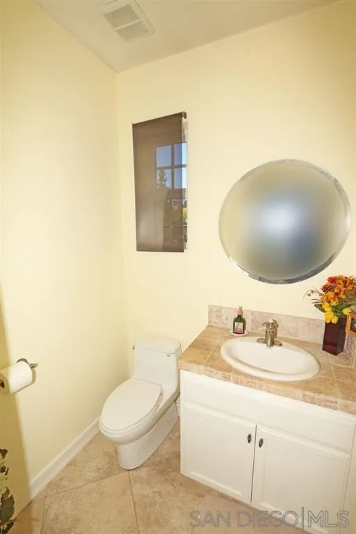 24568 Rutherford Road Ramona, CA 92065 - Photo 20 of 25 a bathroom with a toilet sink and mirror