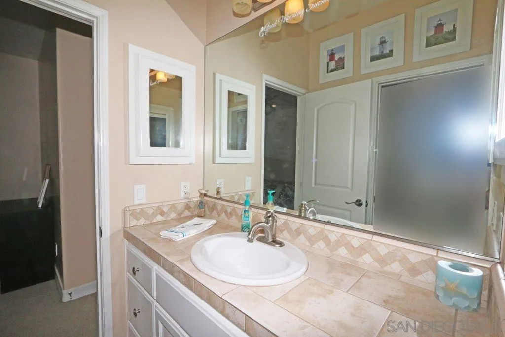 24568 Rutherford Road Ramona, CA 92065 - Photo 8 of 25 a bathroom with a sink and a mirror