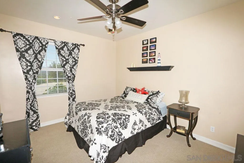 24568 Rutherford Road Ramona, CA 92065 - Photo 9 of 25 a bedroom with a bed and a table in it