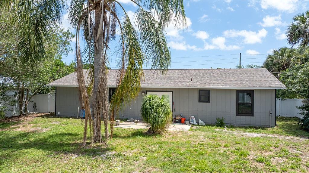 682 Degroodt Road Southwest Palm Bay, FL 32908 - Photo 26 of 27 a backyard of a house with table and chairs