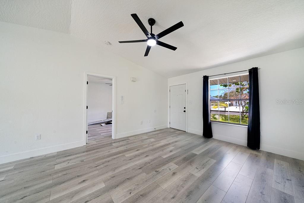 682 Degroodt Road Southwest Palm Bay, FL 32908 - Photo 4 of 27 wooden floor in an empty room with a window