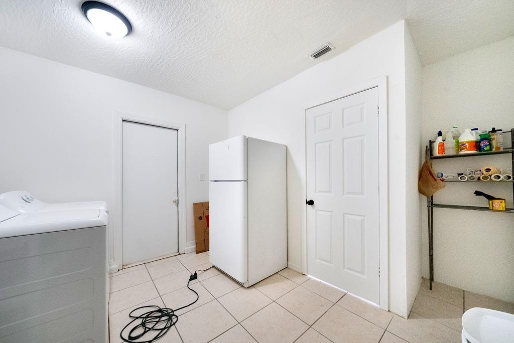 682 Degroodt Road Southwest Palm Bay, FL 32908 - Photo 8 of 27 a view of a storage & utility room with two washing machine