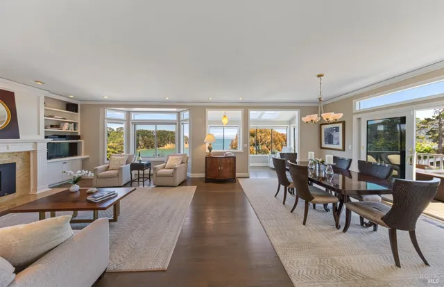 a view of a dining room with furniture large windows and wooden floor