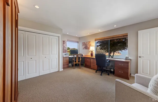 a view of a livingroom with furniture and a large window