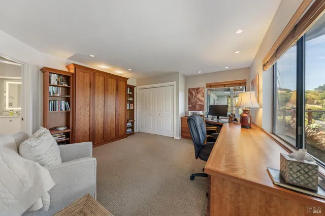 a bathroom with a granite countertop sink a mirror a bathtub and shower