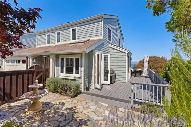 a balcony with wooden floor table and chairs