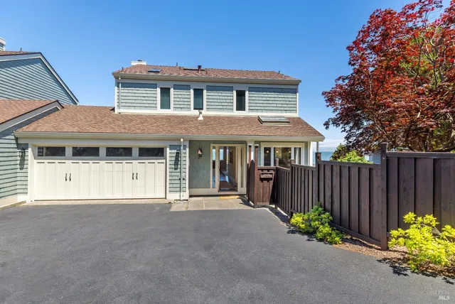 a living room with furniture a fireplace and a large window