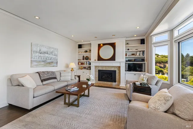 a living room with furniture large window and flat screen tv