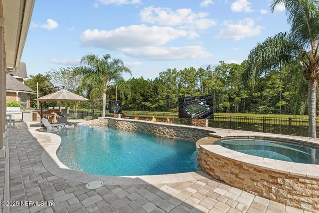 an aerial view of a house with outdoor space and tennis court