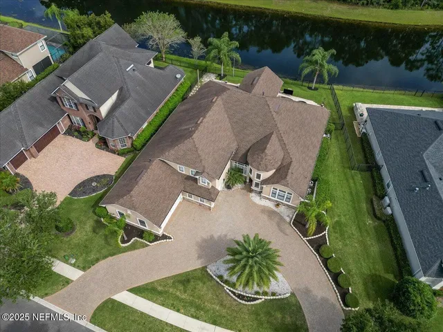 an aerial view of a house with a yard